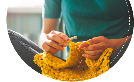 Lady with crochet hook and crafted item