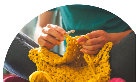 Lady with crochet hook and crafted item